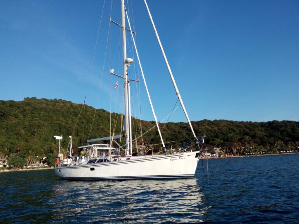 Sailing yacht Hylas H54 (2004) anchored in scenic coastal waters.