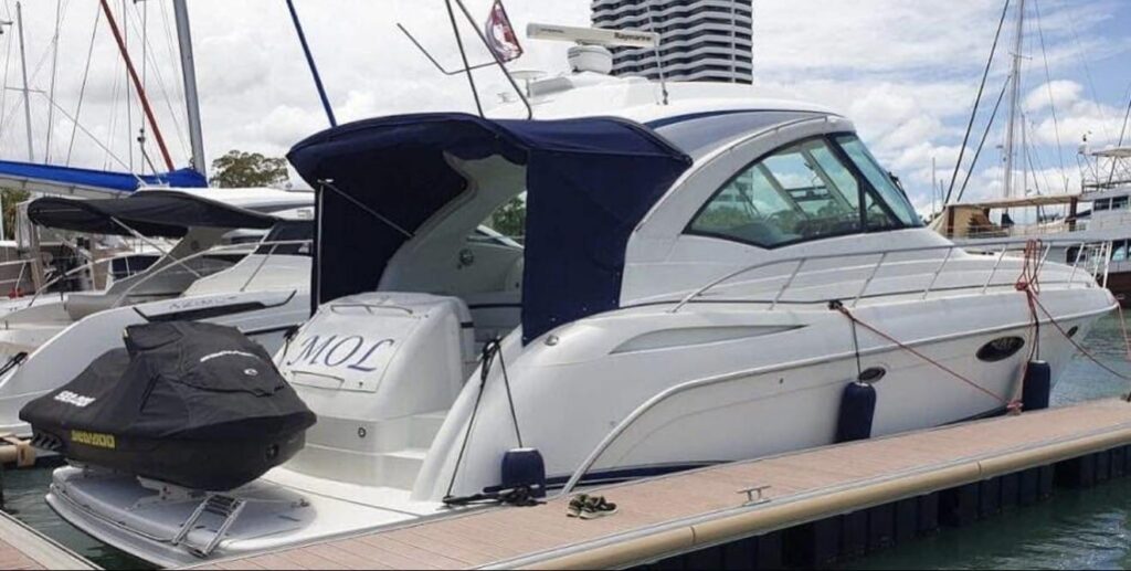 2011 Formula 45 Yacht docked at marina with jet ski on platform.