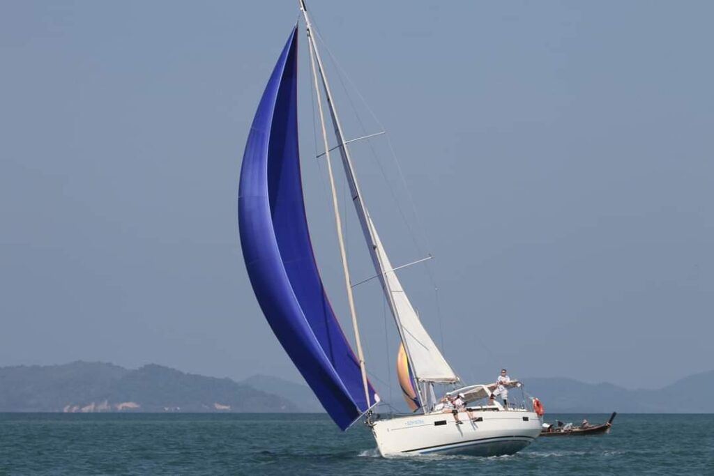 2018 Beneteau Oceanis 45 sailing with blue spinnaker on open water.