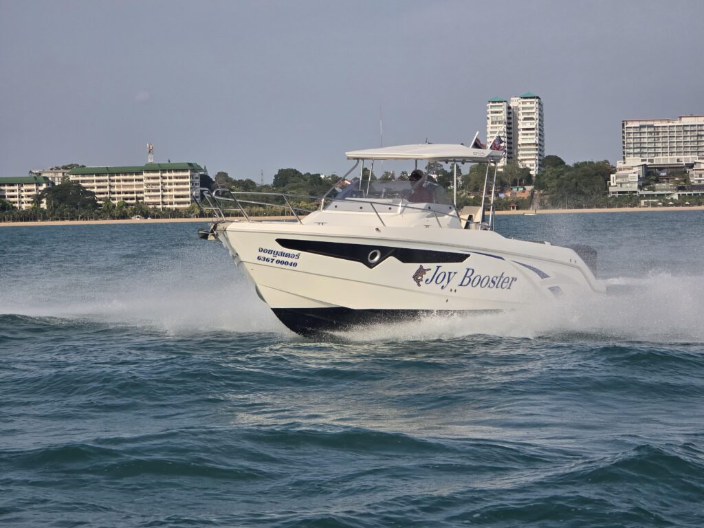 2017 Galia 770 SUNDECK boat cruising near a coastal cityscape.