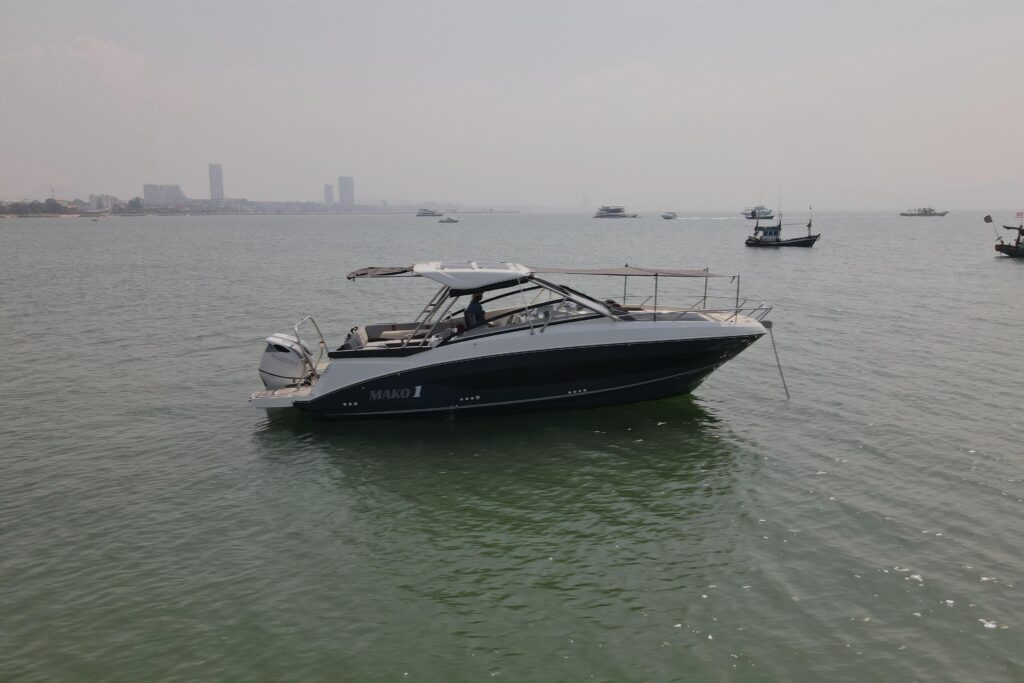 MAKO I boat on the water with city skyline in background.
