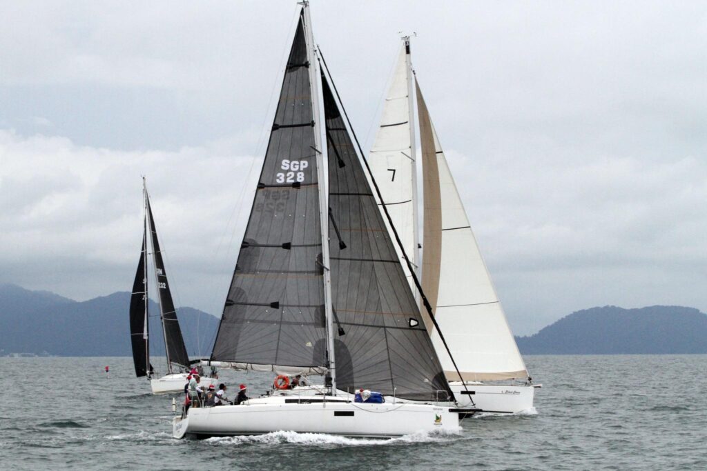 Sailboats racing on the water, including "SGP 328" and "7".
