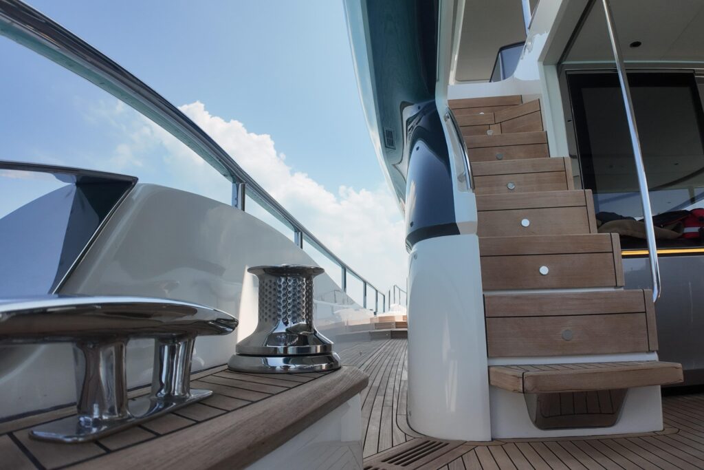 Luxury yacht deck with cleats, stairs, and a view of the sky. La Mer lifestyle.