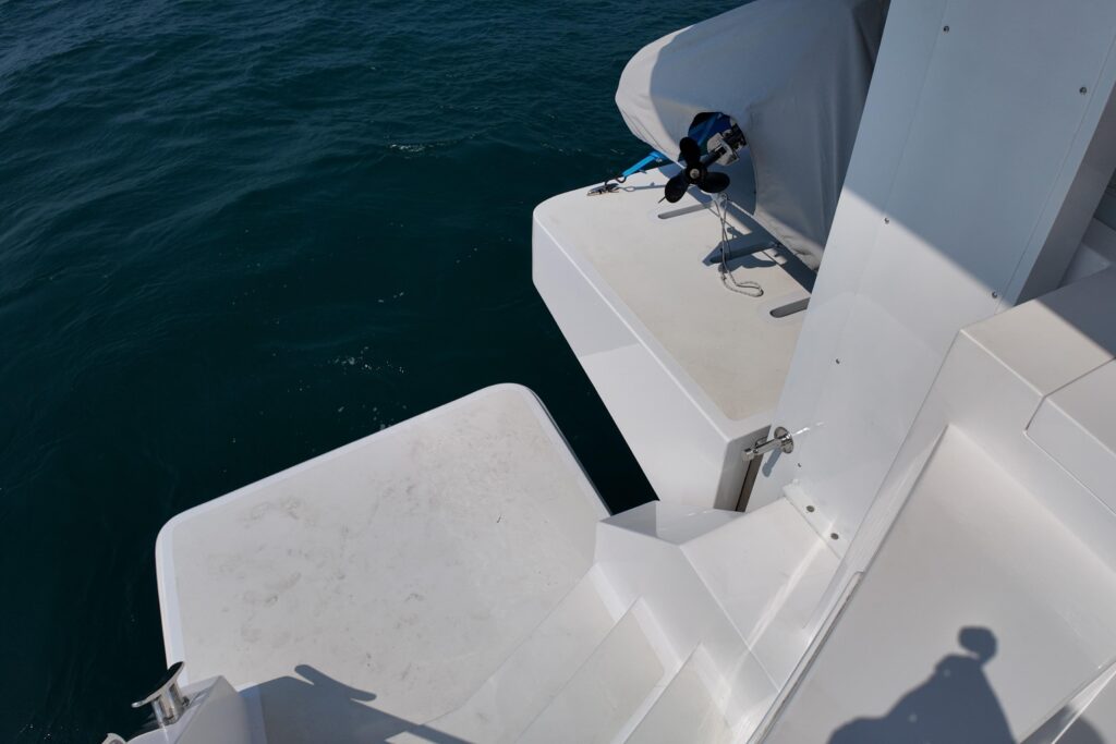 Boat deck detail with white surfaces and ocean view.