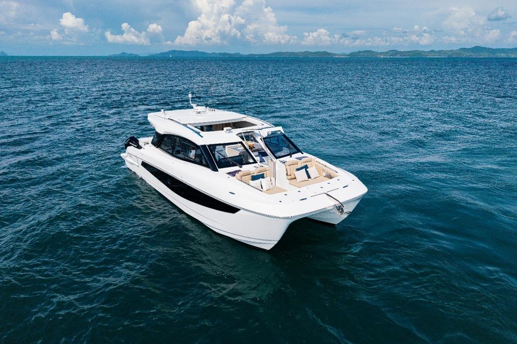 Aquila 42 Coupe 2025 yacht cruising on open sea under clear skies.