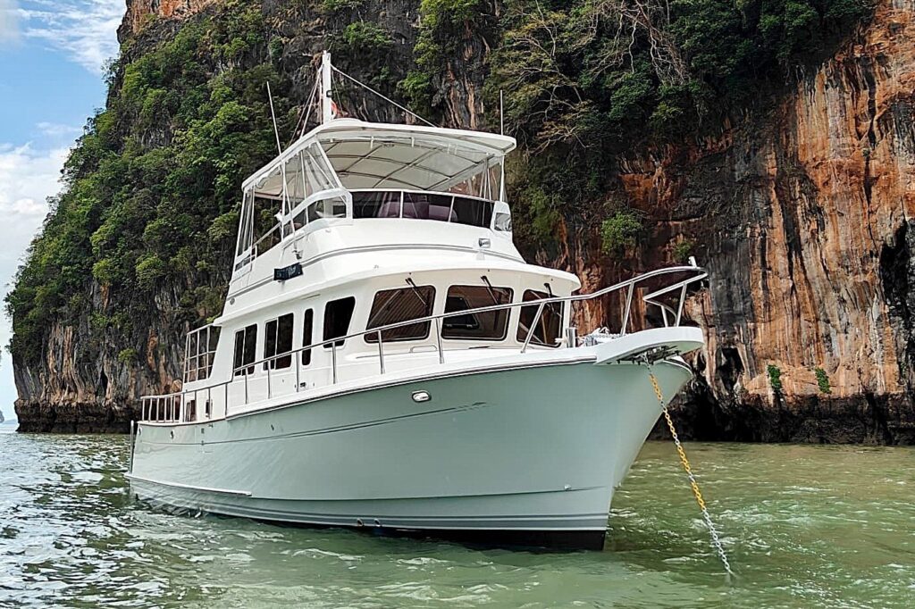 Selene 40 yacht from 2005 anchored near a rocky