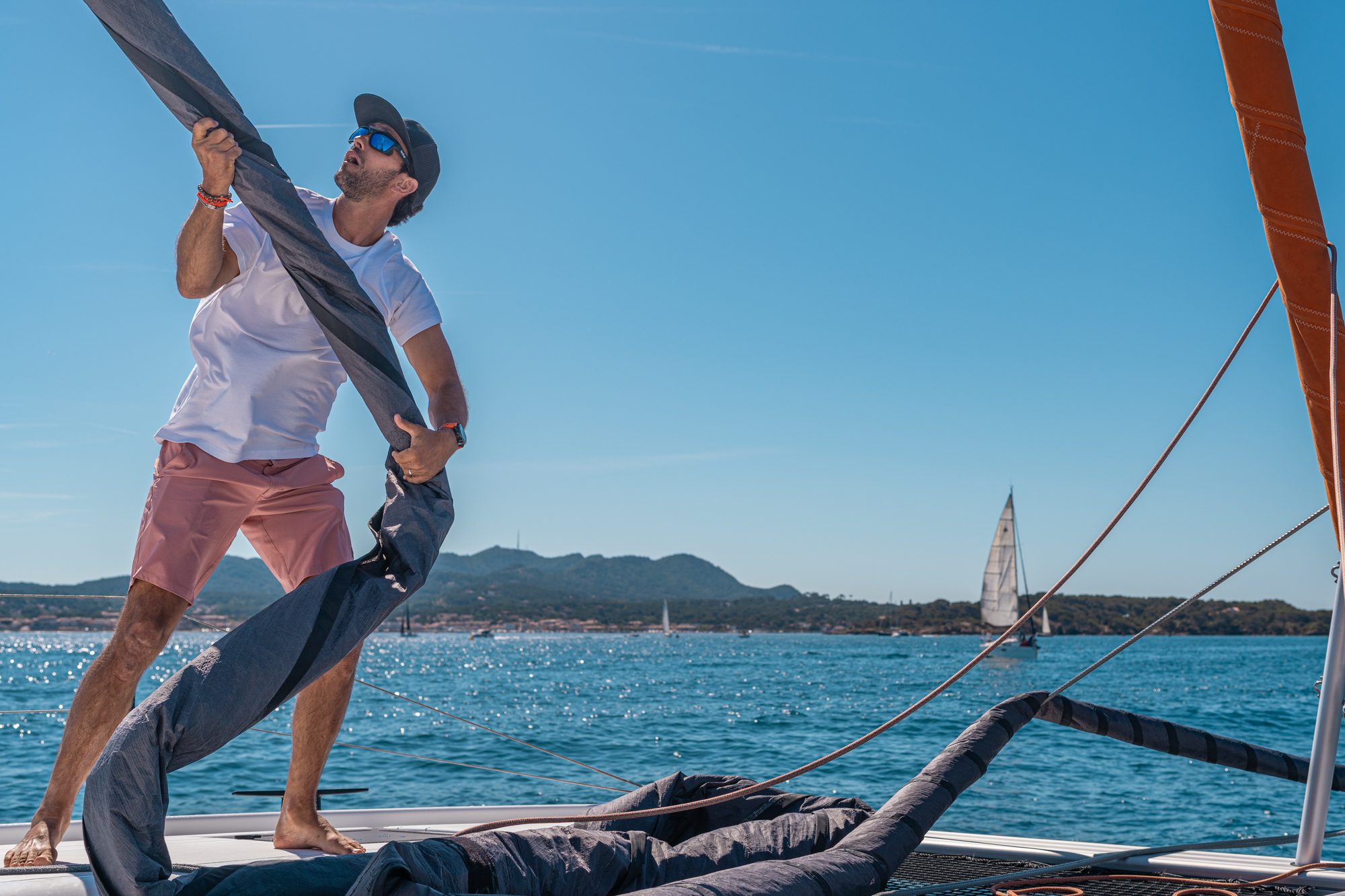 Hoisting the sail aboard an Excess catamaran